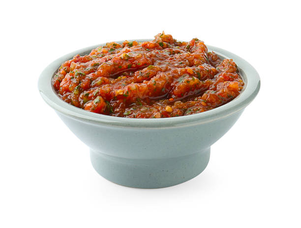 istock Tasty salsa sauce in bowl isolated on white 2234285709