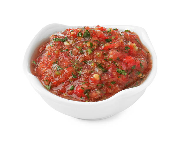 istock Tasty salsa sauce in bowl isolated on white 2234285743