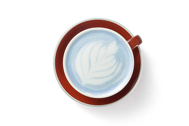 istock Tasty blue matcha latte with foam in cup on red plate white background 2234287116