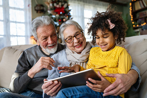 istock Happy grandparents enjoying time with African American grandchild, using tablet computer or e-book 2234288455