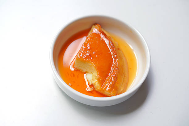 istock Eaten Sweet Caramel Pudding Piece in White Ceramic Bowl. 2234289377
