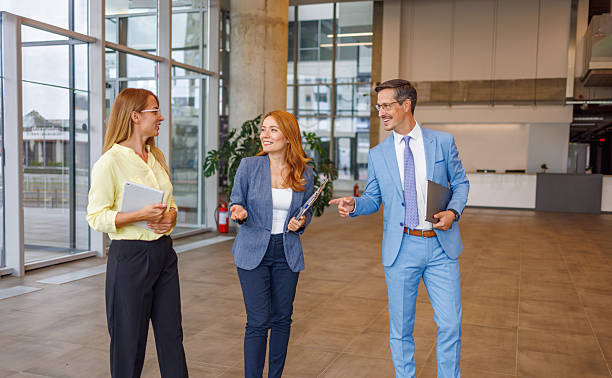 istock Businesspeople walking and talking in modern office 2234291125