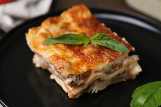 istock Delicious cooked lasagna with basil on plate, closeup 2234291185