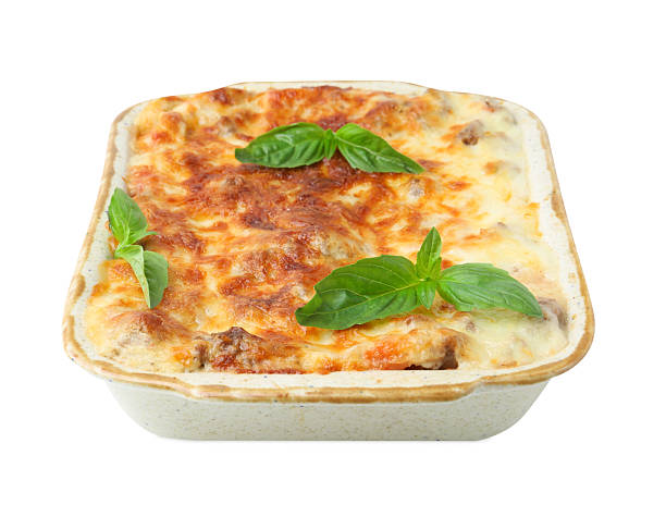 istock Delicious cooked lasagna in baking dish and basil isolated on white 2234291245