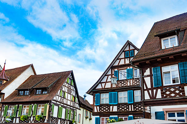 Traditional half timbered house with garden and red flowers in Gengenbach village Black Forest Germany