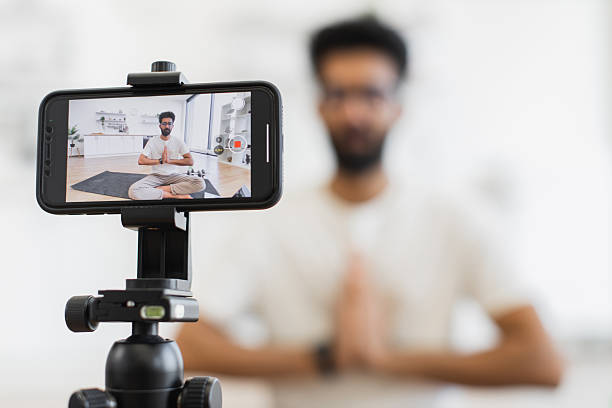 istock Man recording meditation tutorial video indoors for health and mindfulness 2234294310