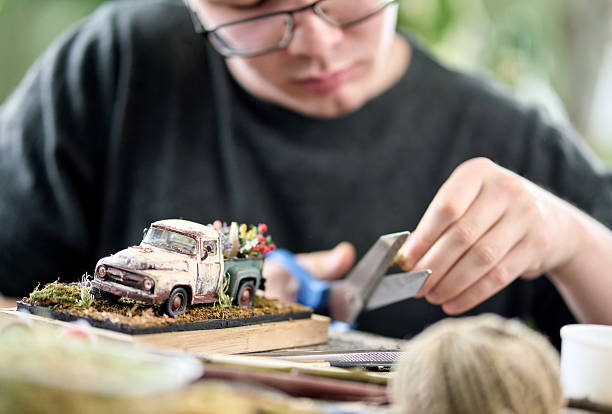 istock Young man doing his favorite hobby sitting at the table, close-up 2234296954