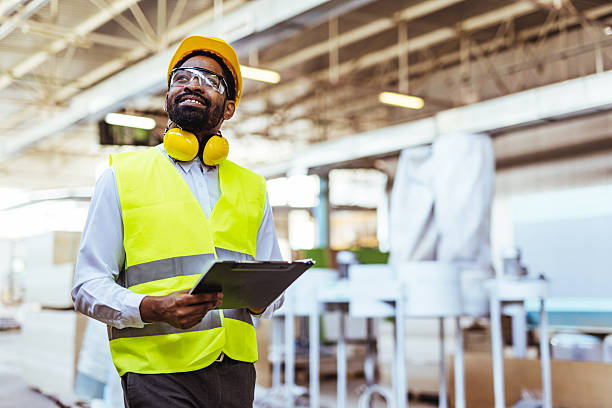 istock Confident Industrial Worker Inspecting Facility with Clipboard and Protective Gear 2234298119