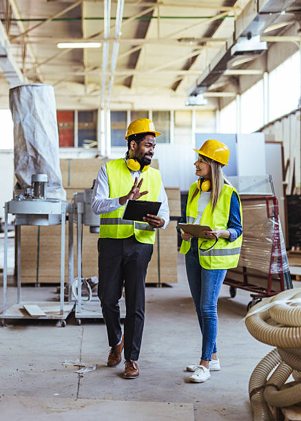 istock Workers Collaborating in Industrial Facility Wearing Protective Gear and Smiling 2234298202