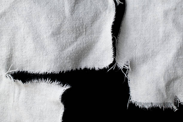 torn old white rag with holes on a black background