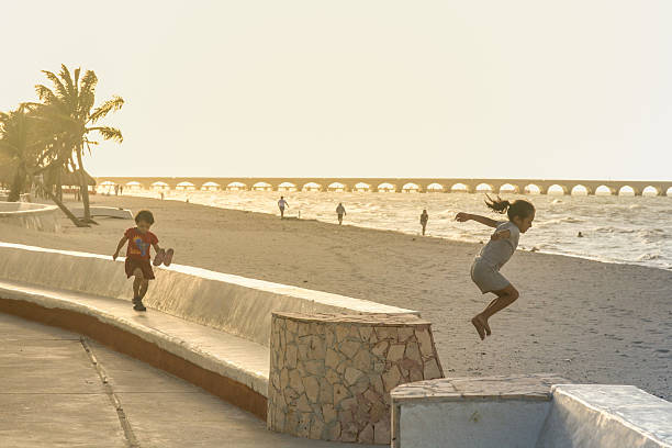 Progreso, Mexico - march 11, 2012: Mexican children have fun on a beach in Progreso near Merida, Yucatan, Mexico