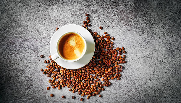 istock Coffee cup and coffee beans on gray background, Espresso crema coffee cup aromatic, top view 2234300955