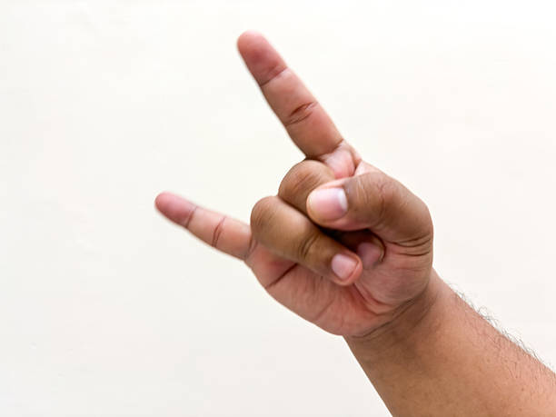 istock Rock on hand gesture against a clean white background symbolizing strength excitement and energy a classic hand sign for music concerts and events conveying a powerful message 2234302736