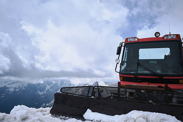 Snow groomer vehicle clearing snow off the ski piste.