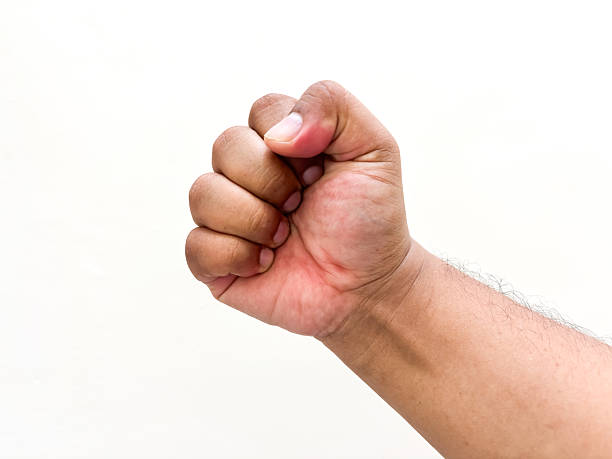 istock Clenched human fist signifying power, determination and strength against a bright background offering versatility for expressing solidarity, resistance, or resolution concept, perfect for diverse use 2234303645