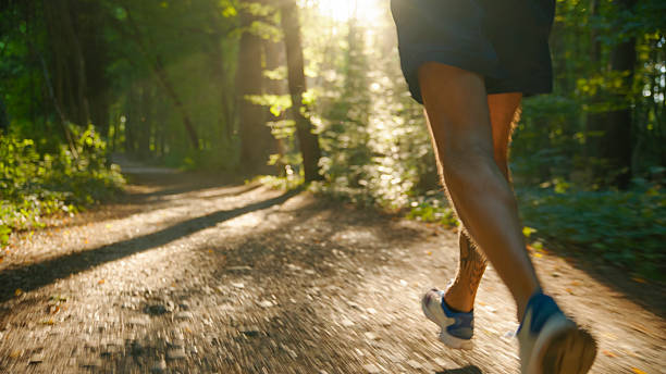 istock Athlete Running on a Forest Trail During a Sunny Day 2234303946
