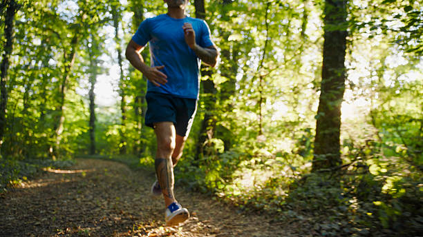 istock Man Running on a Trail in the Forest During Summer 2234304067