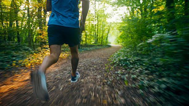 istock Athlete Running Fast on a Trail in the Forest 2234304144