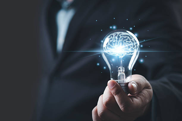 istock A businessman holds a glowing light bulb with a brain inside, symbolizing innovative ideas and creativity. 2234304202