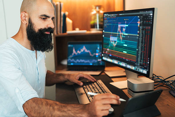 istock Trader investor analyst using multiple displays for cryptocurrency stock market, analyzing graph trading data index investment growth chart, plans strategy 2234309285