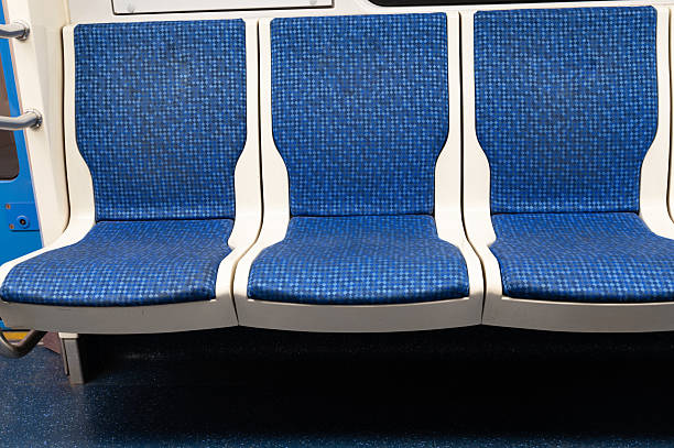 istock There is a row of blue and white seats located on a train 2234309508
