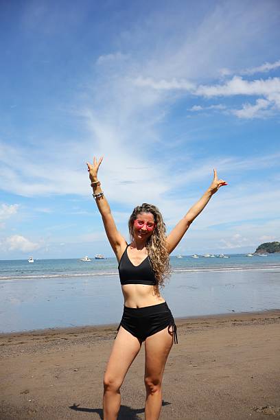 istock Young Woman Relaxing on Sunny Beach 2234309526