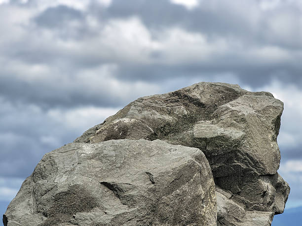 Gray Rock Formation Against Cloudy Sky