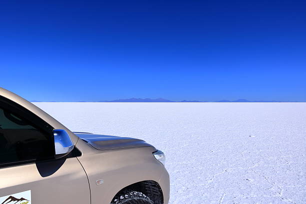 Uyuni in Bolivia - May 27 2025: people explore the salt flat by car