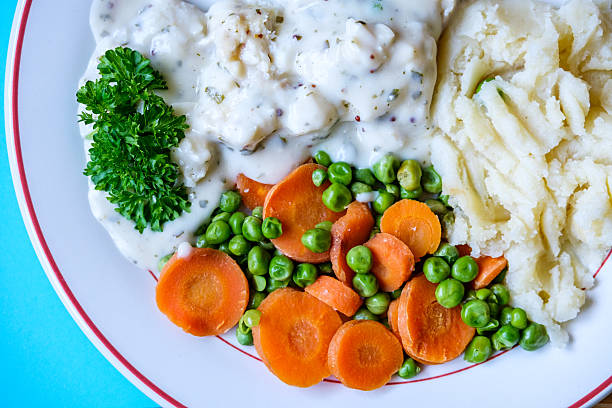 London UK, September 08 2025, Cod Fillet Fish With Mashed Potatoes Carrots And Peas In A Pasley Sauce