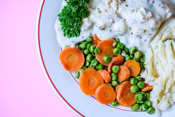 London UK, September 08 2025, Cod Fillet Fish With Mashed Potatoes Carrots And Peas In A Pasley Sauce