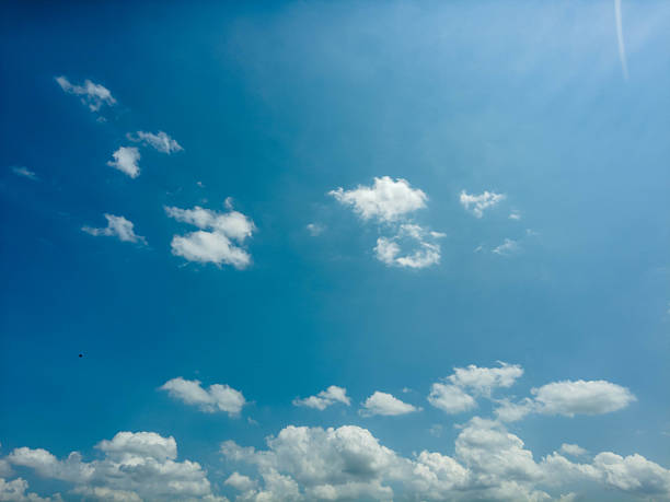 istock Clear Blue Sky With Scattered White Clouds During Midday in a Serene Atmosphere 2234317656