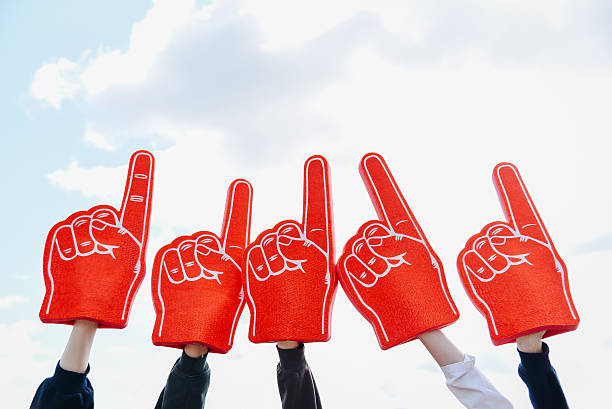 young woman hand with large red rubber glove with pointing finger, pointing up to the sky, volunteer work, setting direction
