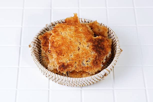 Korean nurungji, crispy scorched rice served on a ceramic plate with woven mat, showcasing traditional texture and authentic Asian food culture.