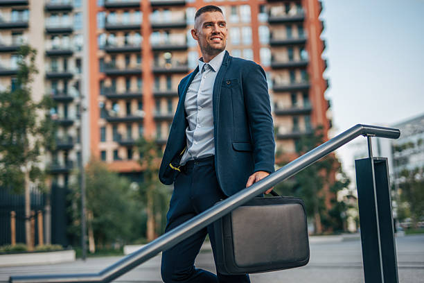 istock Businessman walking down stairs in urban setting 2234323020
