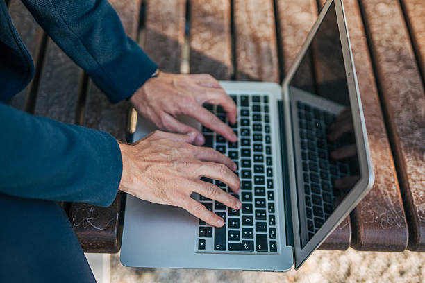 istock Businessman working on laptop outdoors in a park 2234323146