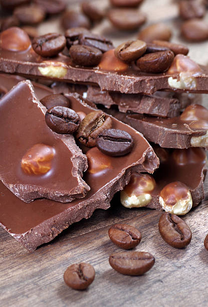coffee and chocolate. pieces of milk chocolate with hazelnuts and coffee beans. close up