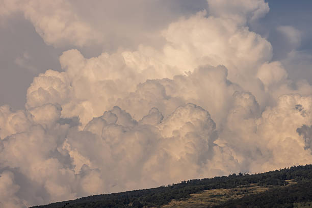 Cumulus clouds on mountain with blue sky.