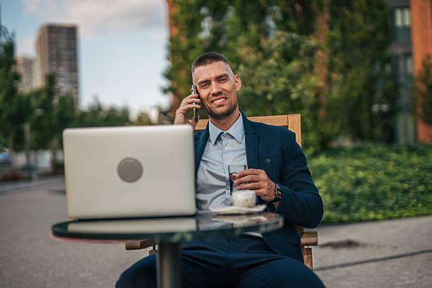 istock Businessman working outdoors with laptop and phone 2234326880