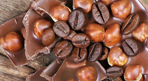 coffee and chocolate. pieces of milk chocolate with hazelnuts and coffee beans. close up
