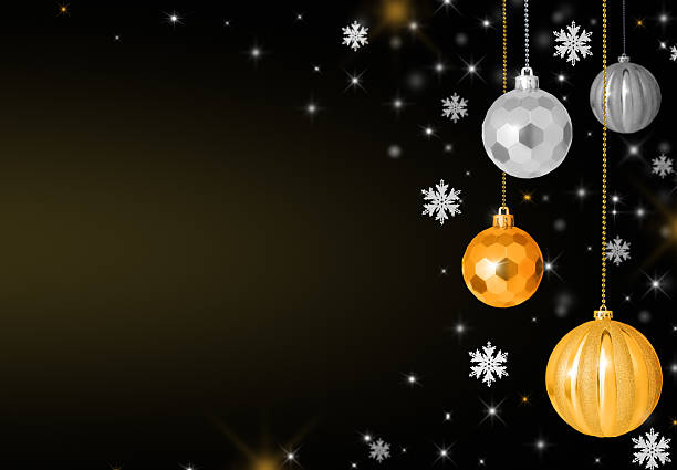 Elegant Christmas background with golden and silver baubles and sparkling snowflakes on a dark black gradient backdrop. Festive holiday decoration concept with copy space for text, greeting cards, banners, and seasonal design.