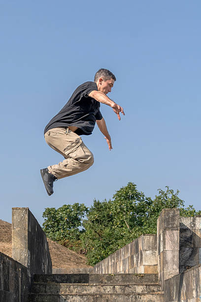 istock Traceur jumping over concrete walls in urban parkour training 2234329166