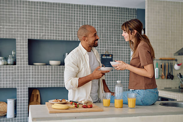 istock Happy couple sharing breakfast in modern kitchen 2234330379