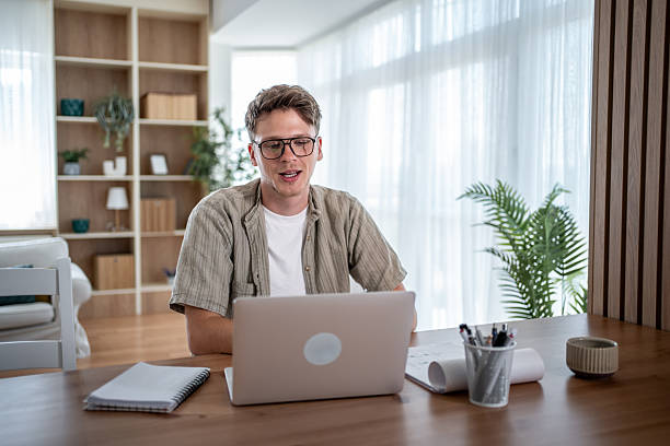istock Young man working from home having a video call on laptop 2234331560
