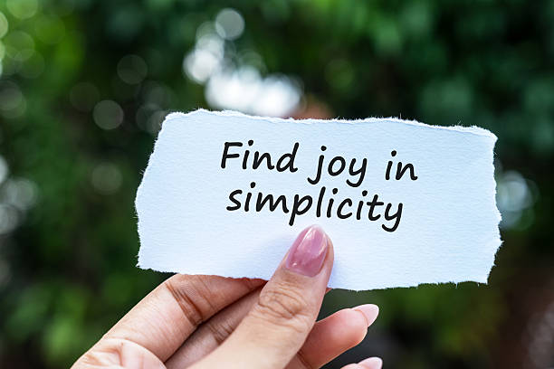istock Hand holding a paper note with quotes find joy in simplicity 2234334040