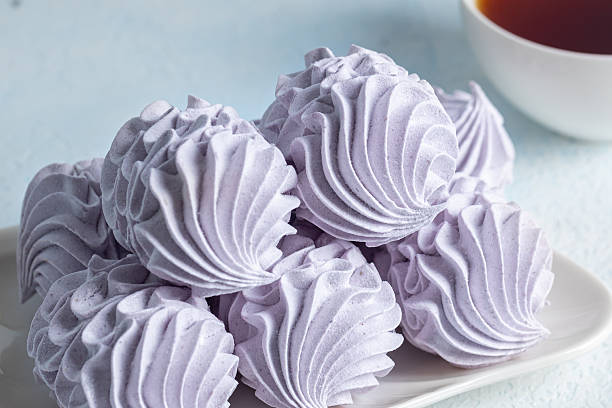 istock Delicate homemade lavender zephyr arranged beautifully on a light background, showcasing intricate textures and soft colors, perfect for dessert lovers and culinary enthusiasts 2234334041