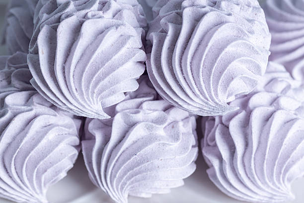 Homemade lavender zephyr displayed on a light background, highlighting its delicate texture and pastel hue, ideal for dessert presentations and culinary inspiration