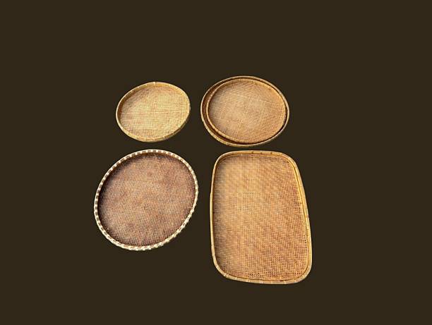 The brown background in the picture is a brown tray or winnowing basket woven from bamboo decorated with beautiful patterns. It is strong and sturdy. It is a circular tray used to hold various things.