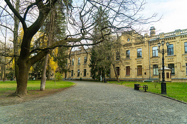 istock Ornate brick building with many windows and green spaces under a cloudy sky 2234334962