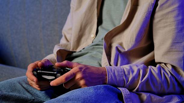 istock Man Relaxing at Home While Playing Video Games 2234336128