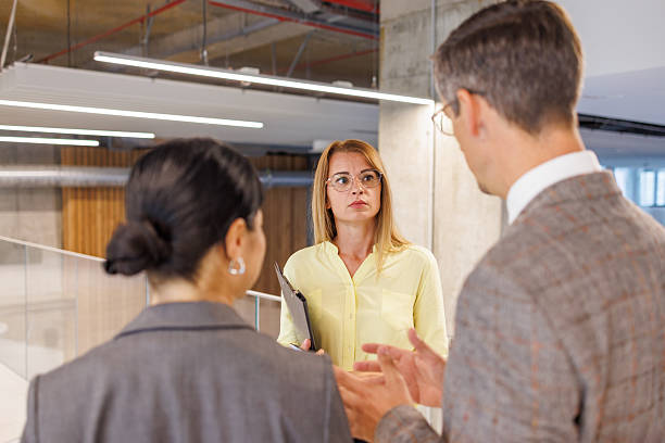istock Businesspeople discussing work in modern office corridor 2234337797